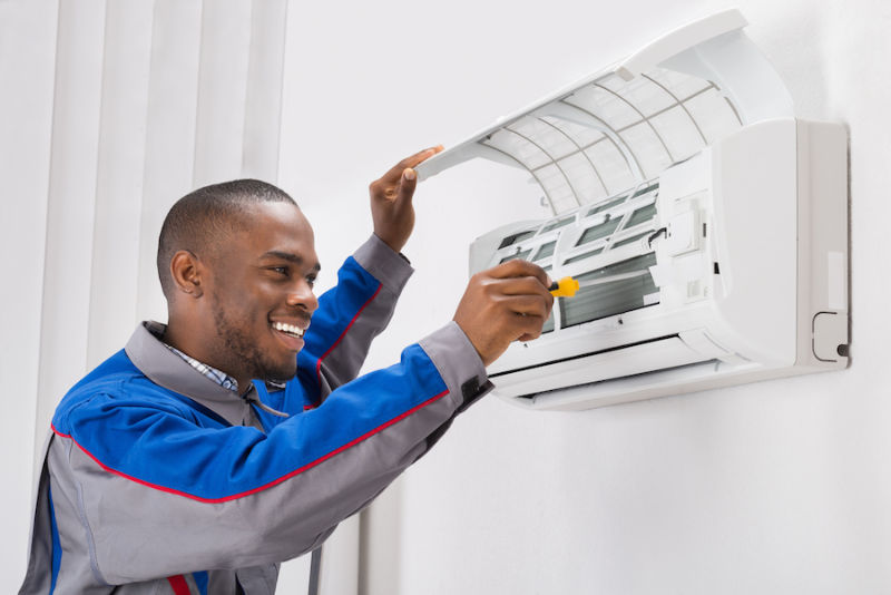 Technician Fixing Ductless AC