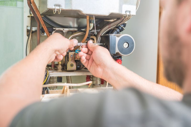 Technician Repairing Furnace