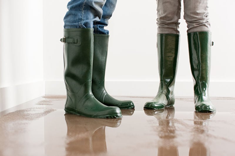 Couple standing in flooded home