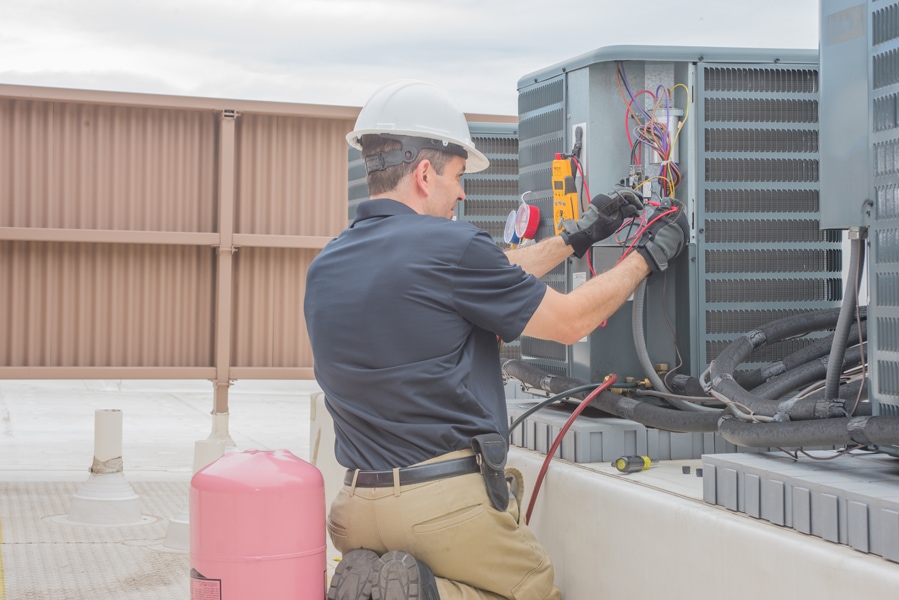 HVAC Tech Checking Condenser