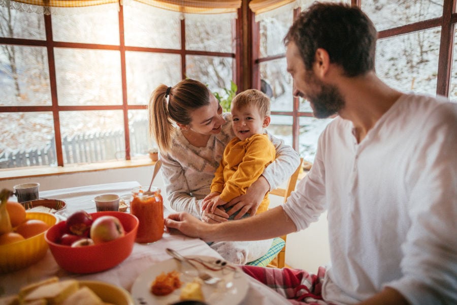 happy family in the kitchen in fall around the table with fall baking.