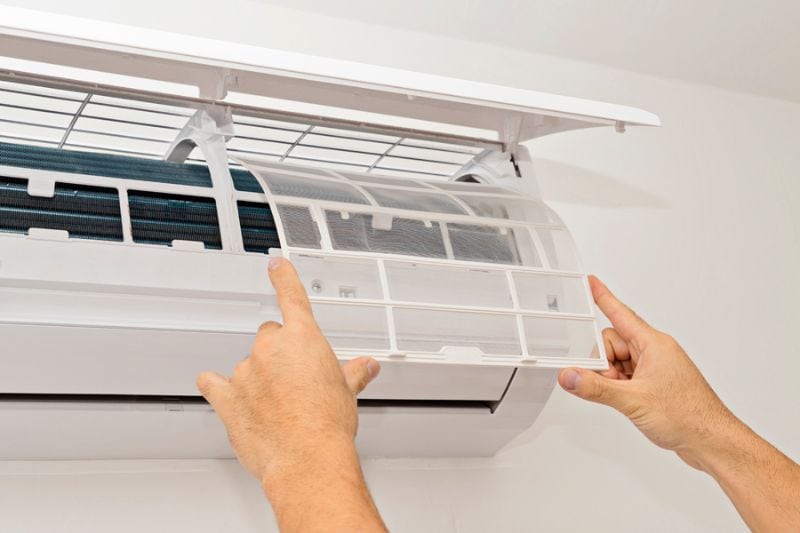 Image of someone changing filter on ductless system. What Maintenance Is Needed for a Ductless System?