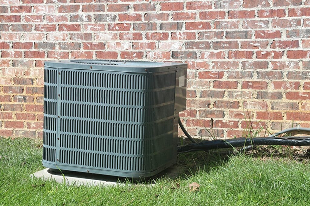 How Do You Know When to Repair or Replace Your AC Equipment? AC unit outside building.